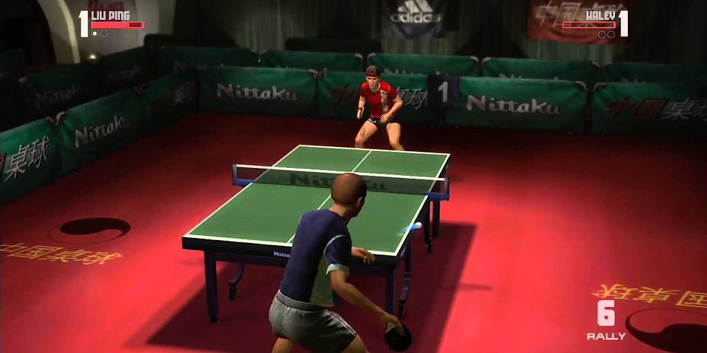 Two competitors play table tennis in a dark room