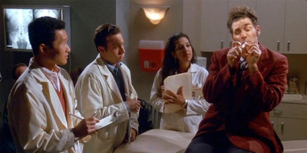 Kramer lights a cigarette as he speaks to medical students in a hospital