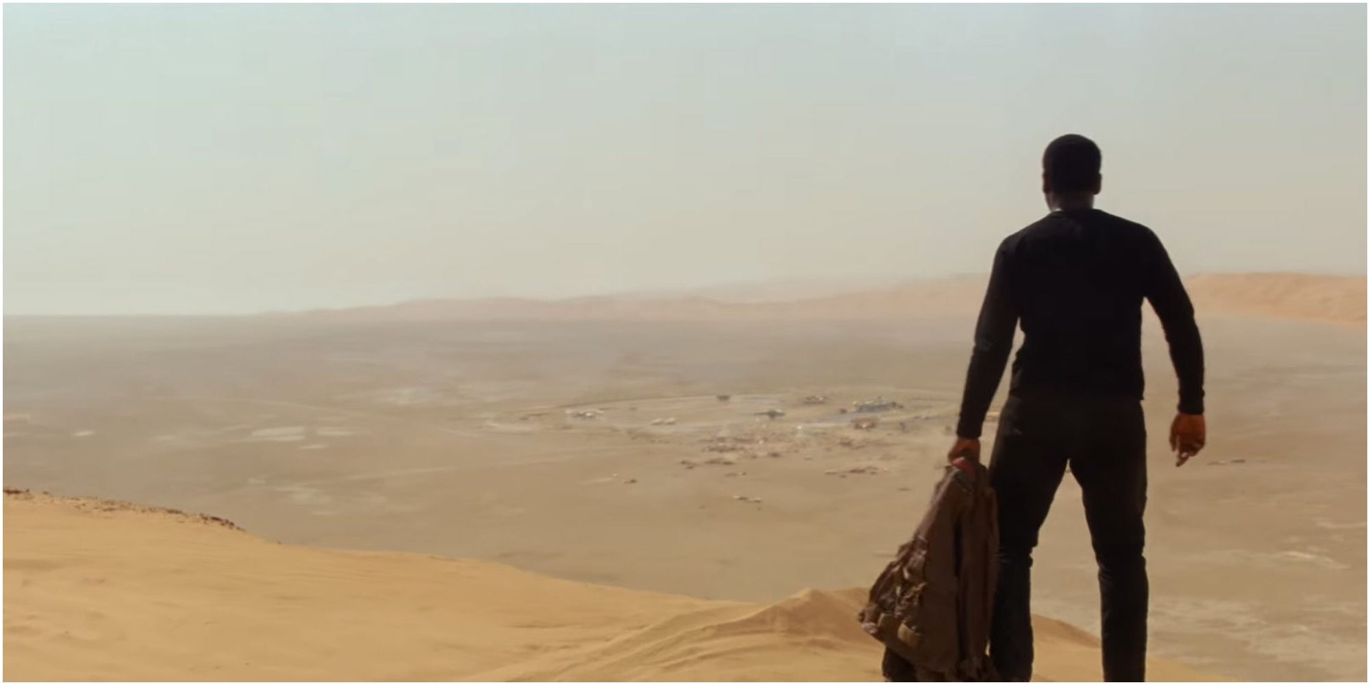 Finn looking out on a desert on Jakku