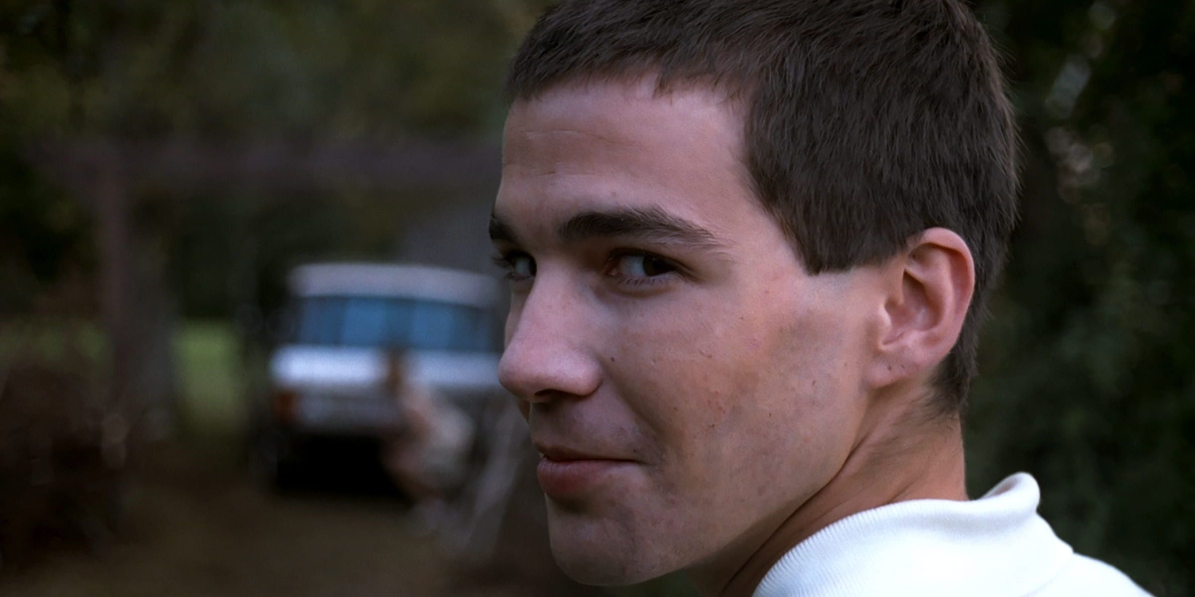 A man stares at the camera with a malicious grin in Funny Games