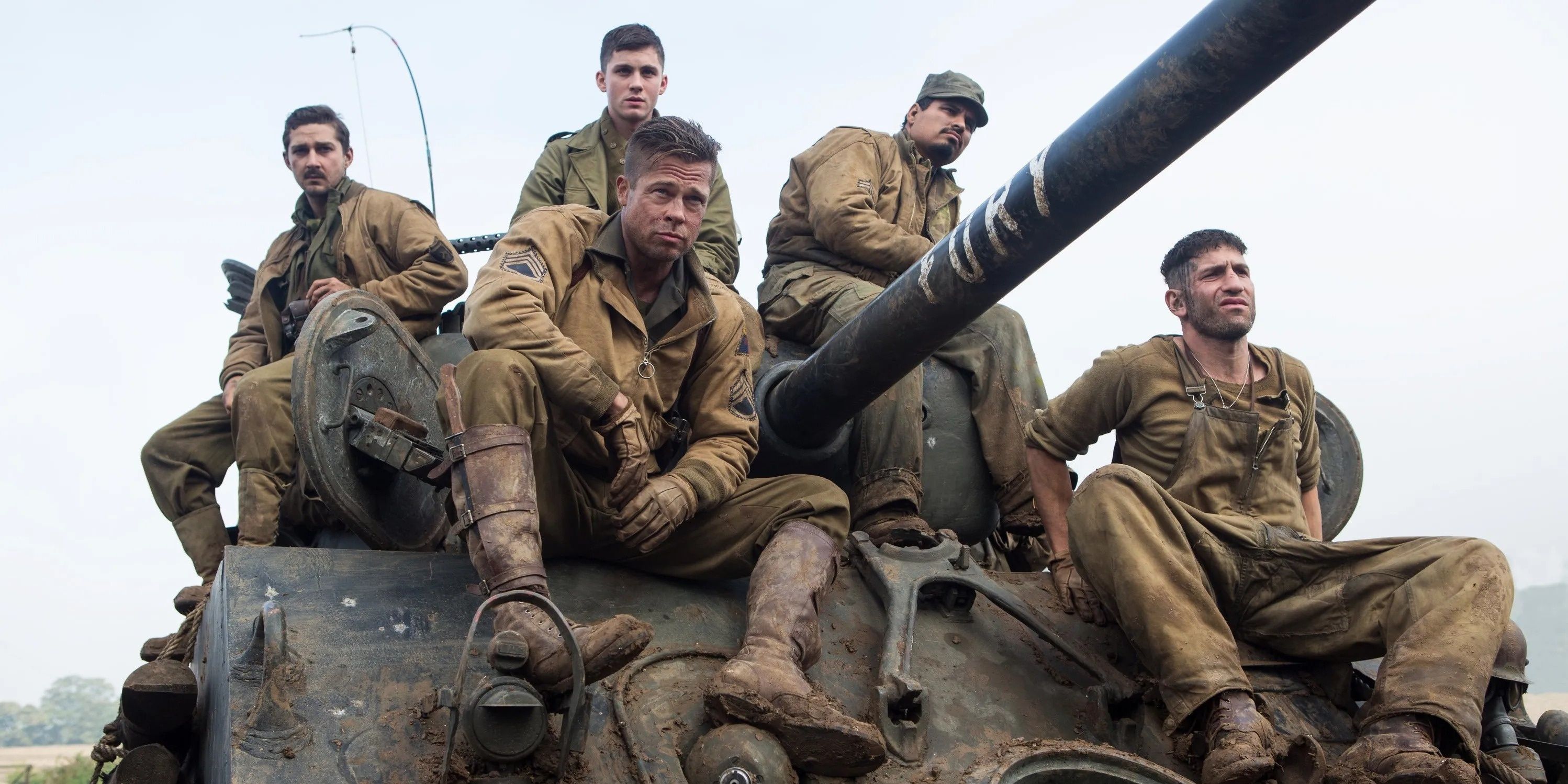 Brad Pitt and fellow soldiers sitting on top of tank in Fury