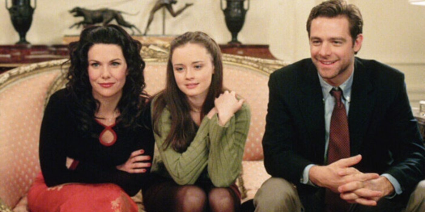 Lorelai, Rory, and Christopher sitting on a couch on Gilmore Girls