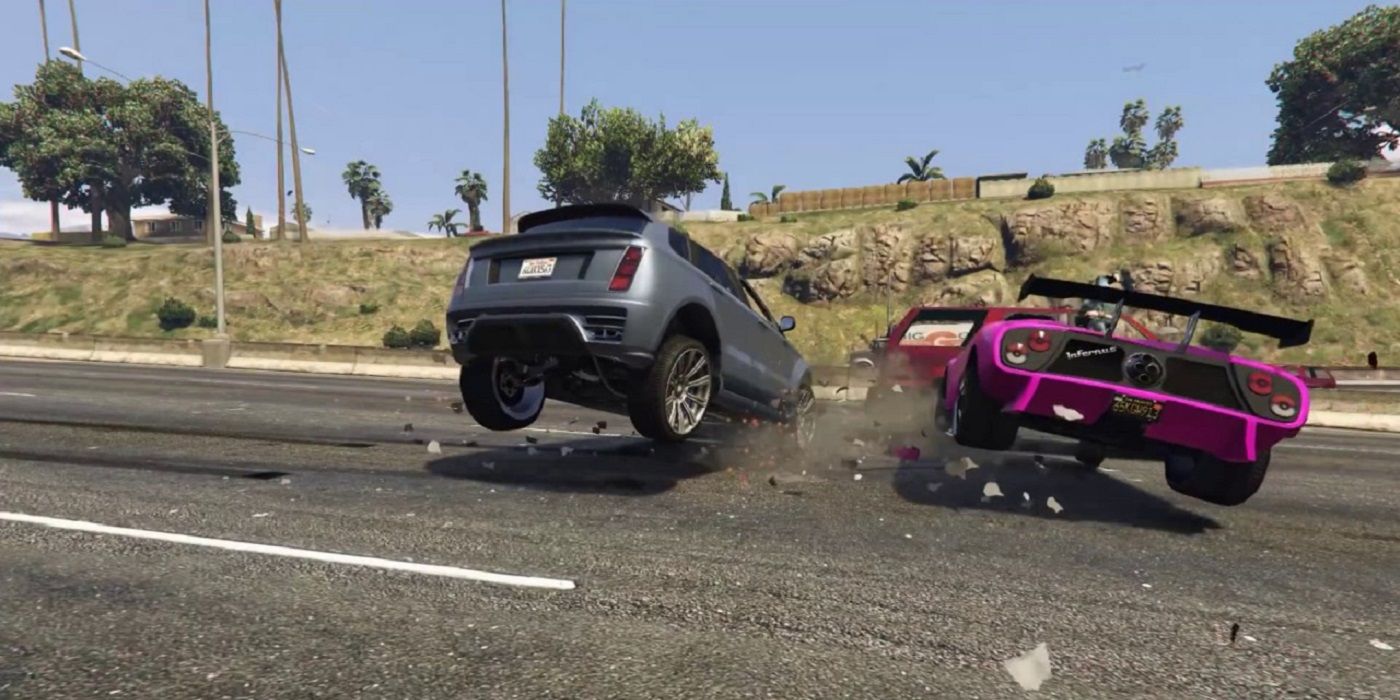 A pink sports car crashes in to two other cars