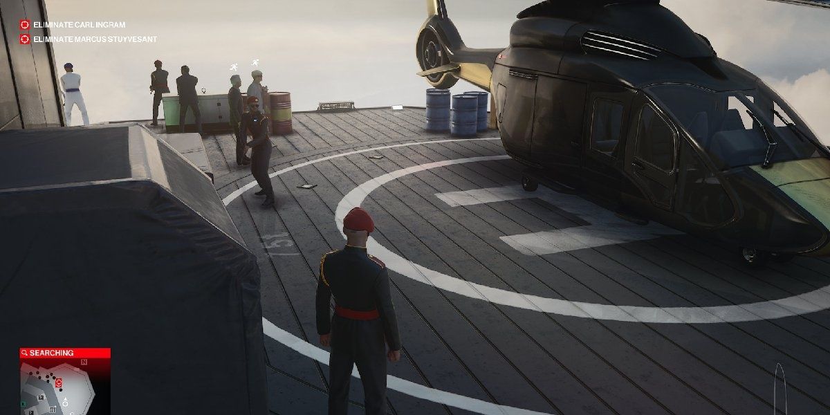 An image of Agent 47 standing on a helicopter pad in Hitman 3