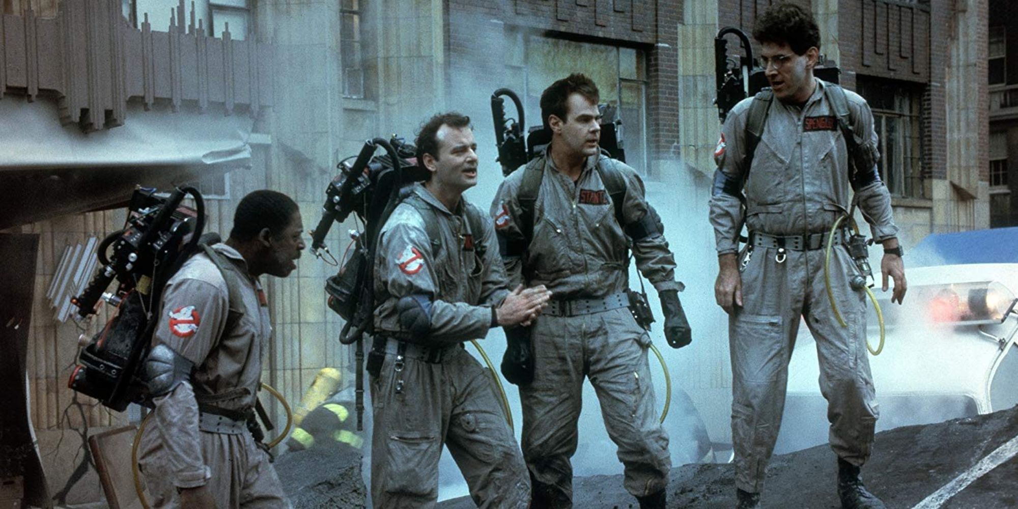 An image of all four Ghostbusters standing in a line holding their weapons in the Ghostbuster movie