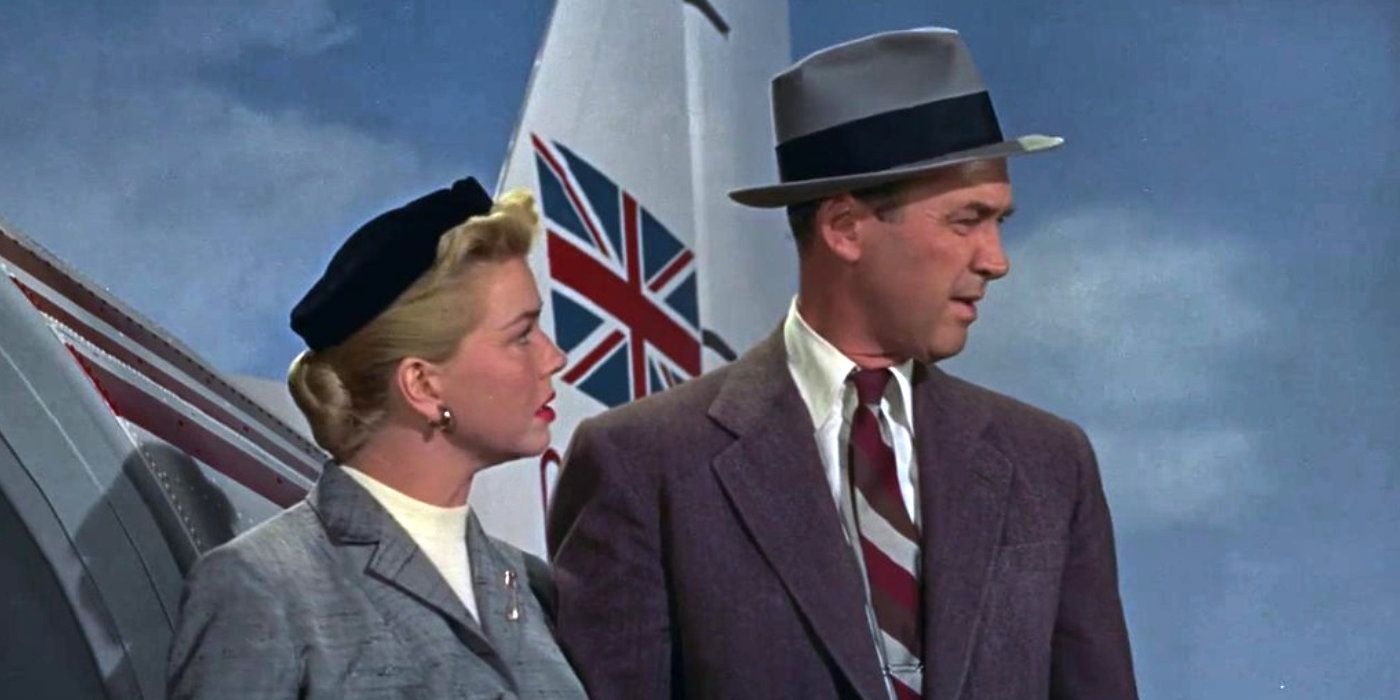 A man and woman stand in front of an airplane in The Man Who Knew Too Much