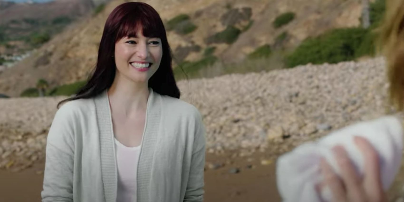 Lexie Grey smiling on the beach in Grey's Anatomy