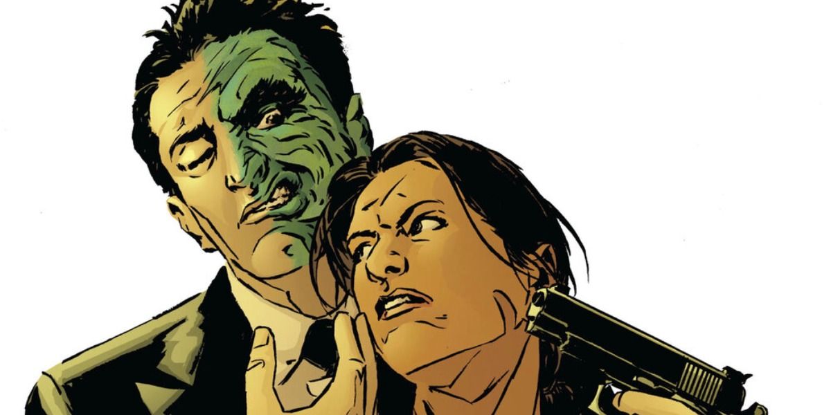 Two Face caresses Renee Montoya's face while holding a gun up to her head.