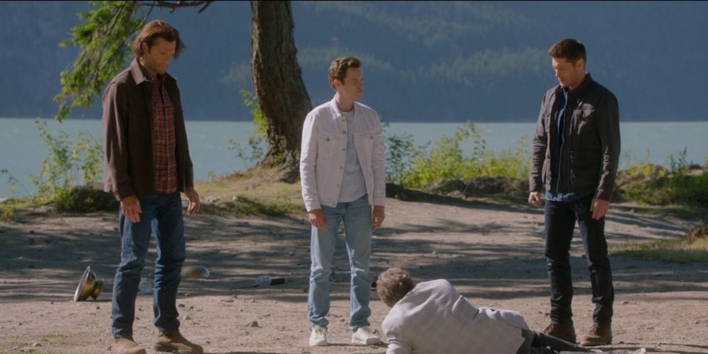 Dean and Sam look at a man on the floor in Supernatural