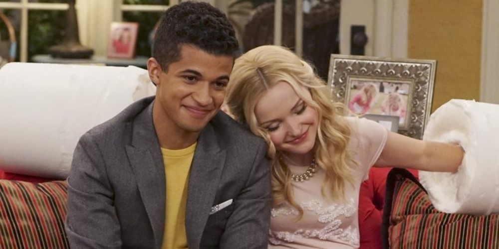 Holden and Liv cuddle in a sofa in Liv and Maddie