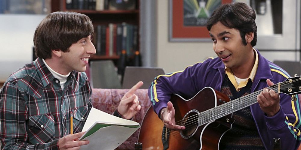 TBBT: Howard and Raj smiling at band rehearsal. Howard holds a notebook and Raj plays guitar.