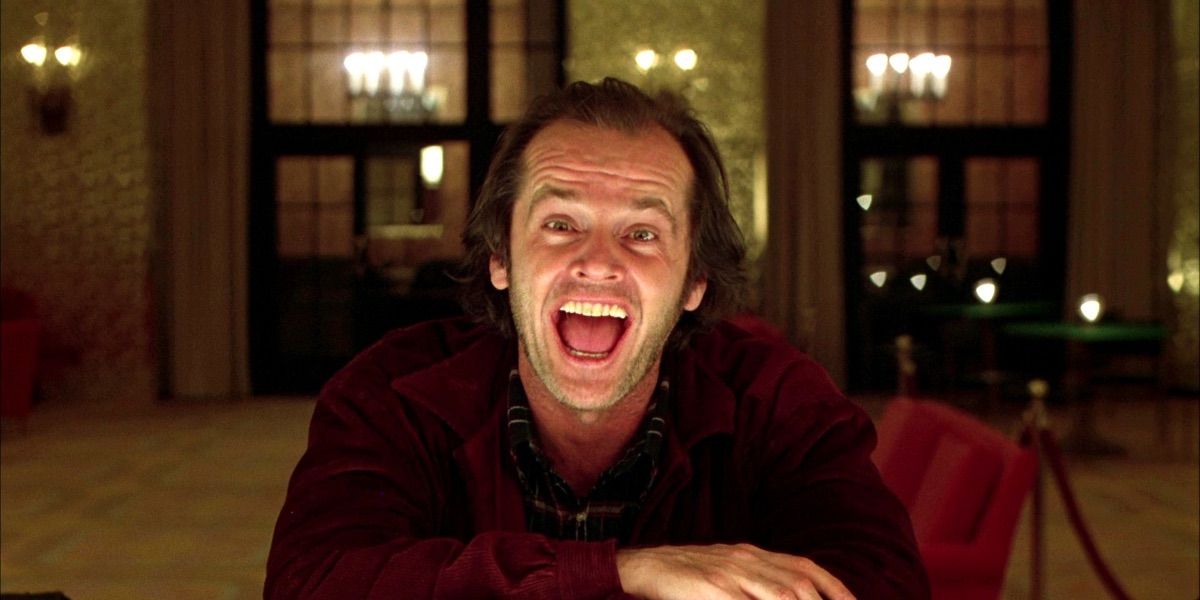 Jack Torrance laughing at the camera in The Gold Room of the Overlook Hotel in The Shining