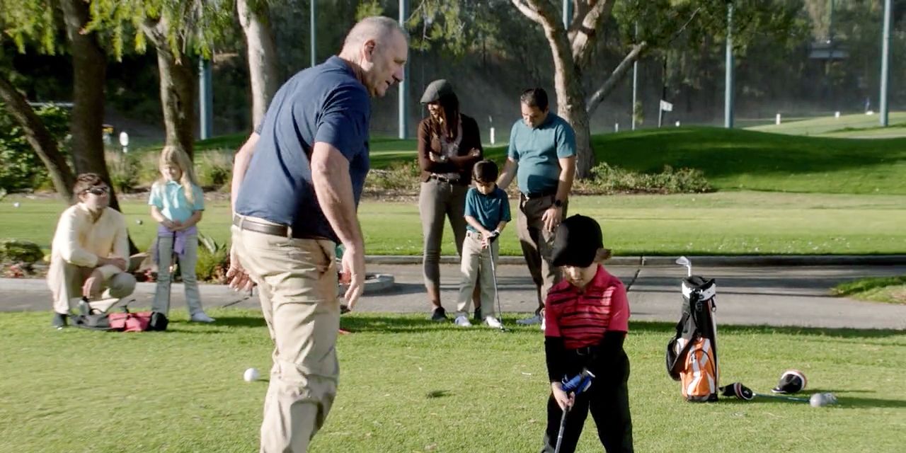 Jay teaching Joe how to play golf in Modern Family episode He Said She Shed