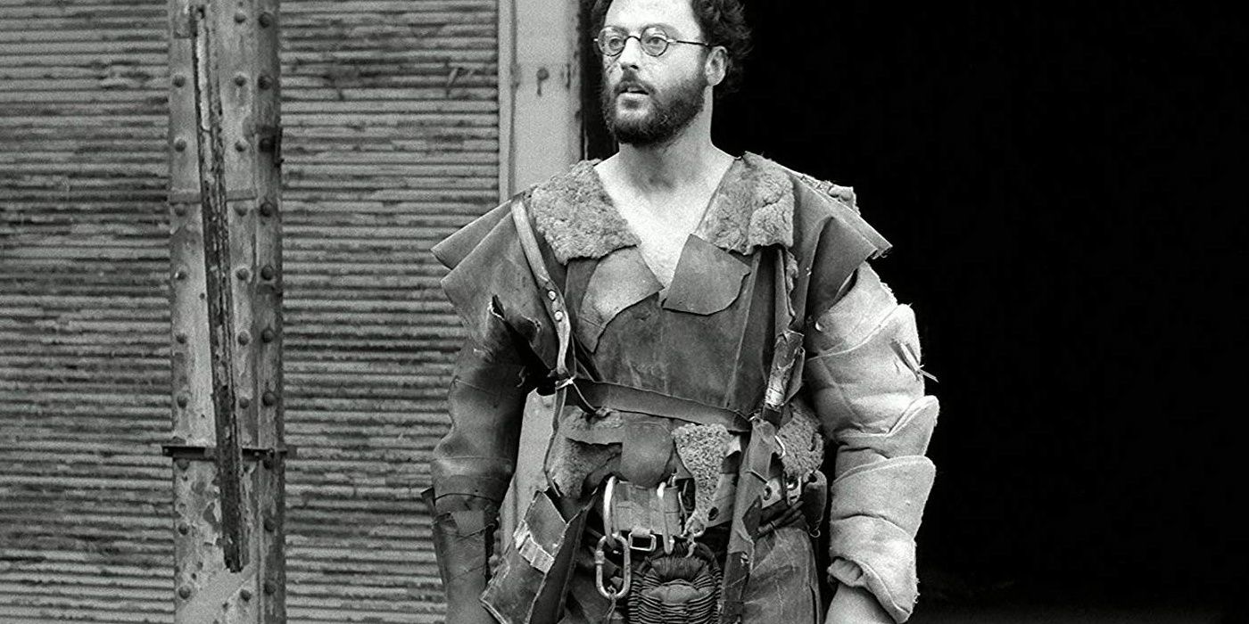 Jean Reno walking in a post-apocalyptic setting in a still from Le Dernier Combat
