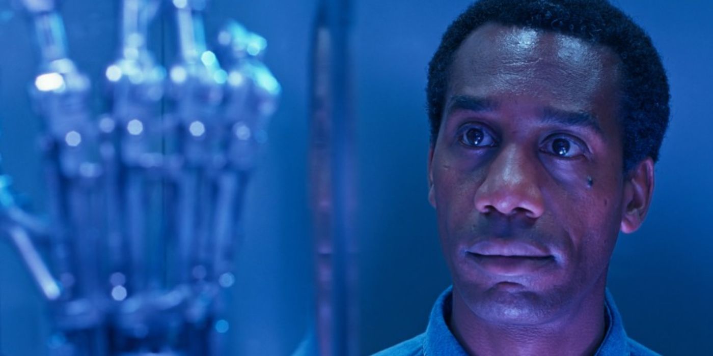 Joe Morton staring at a cybernetic hand in a still from Terminator 2