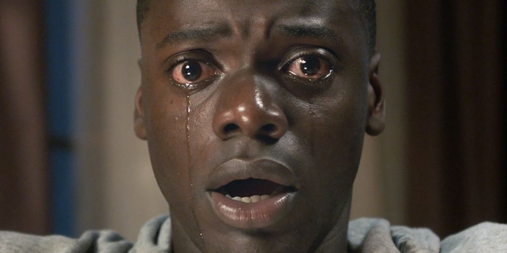 Daniel Kaluuya with tears in his eyes, scared in Get Out