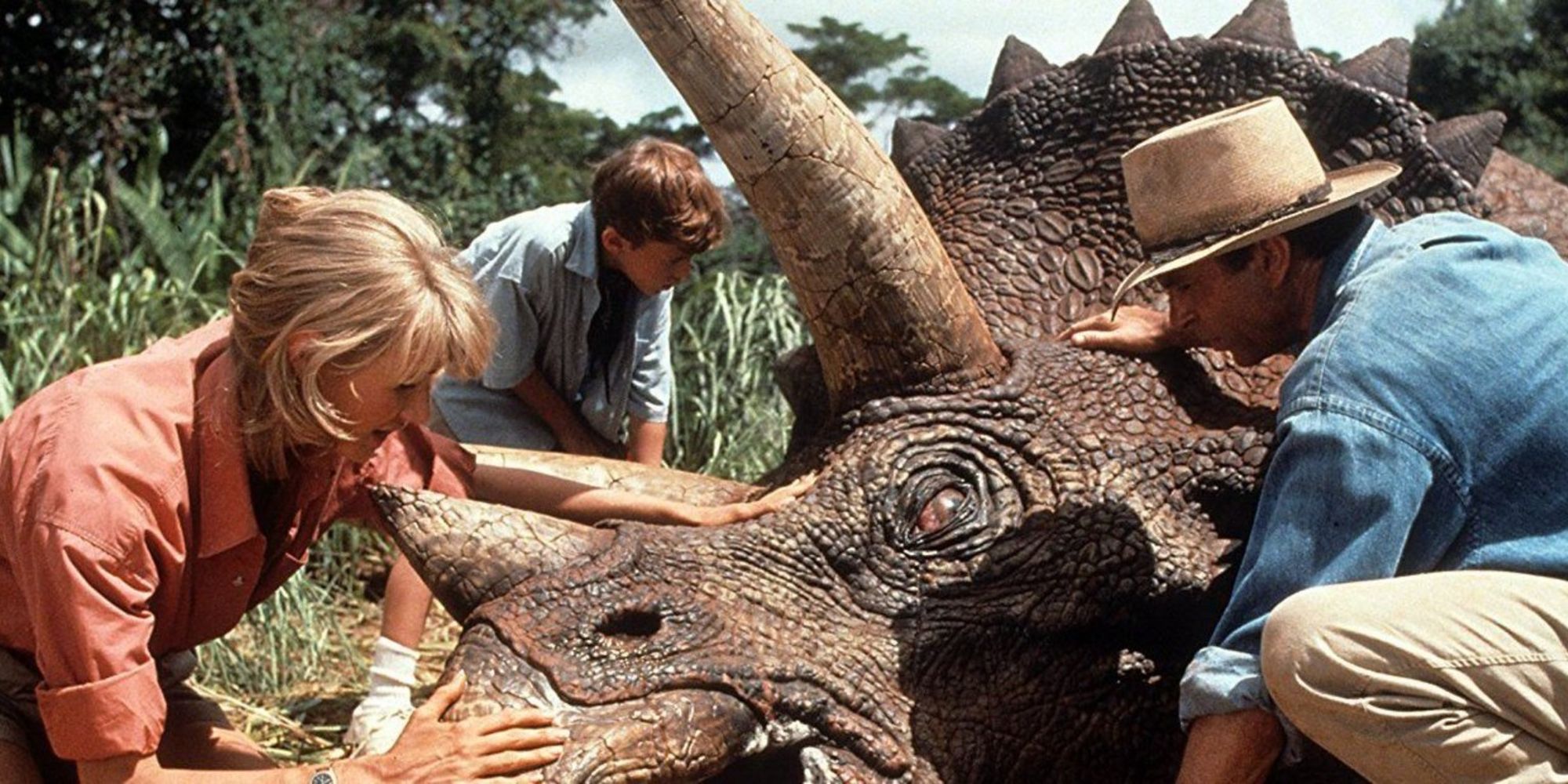 An image of Sam Neill sitting next to a Dinosaur
