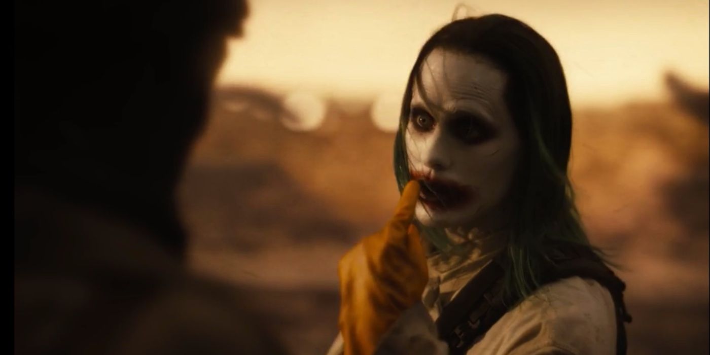 Joker points at his own face while talking to Batman in Zack Snyder's Justice League