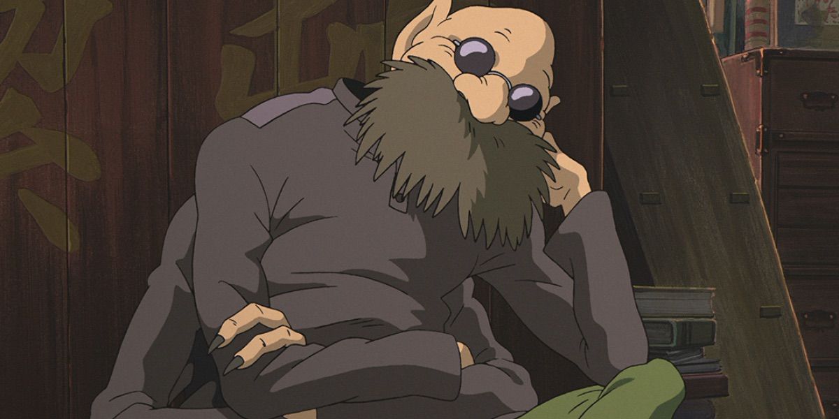 Kamaji from Spirited Away sitting with head resting on elbow and sunglasses on.