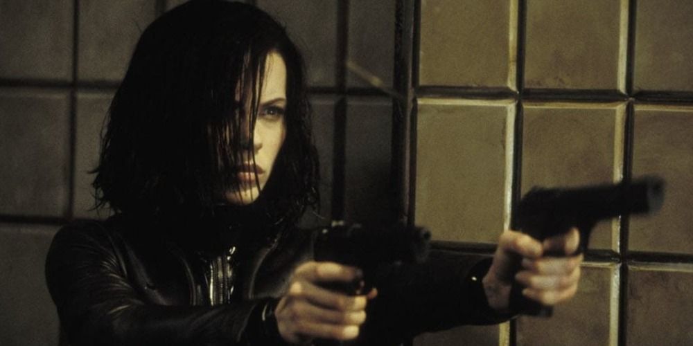 Kate Beckinsale pointing two guns against a tiled wall in the subway at the beginning of Underworld