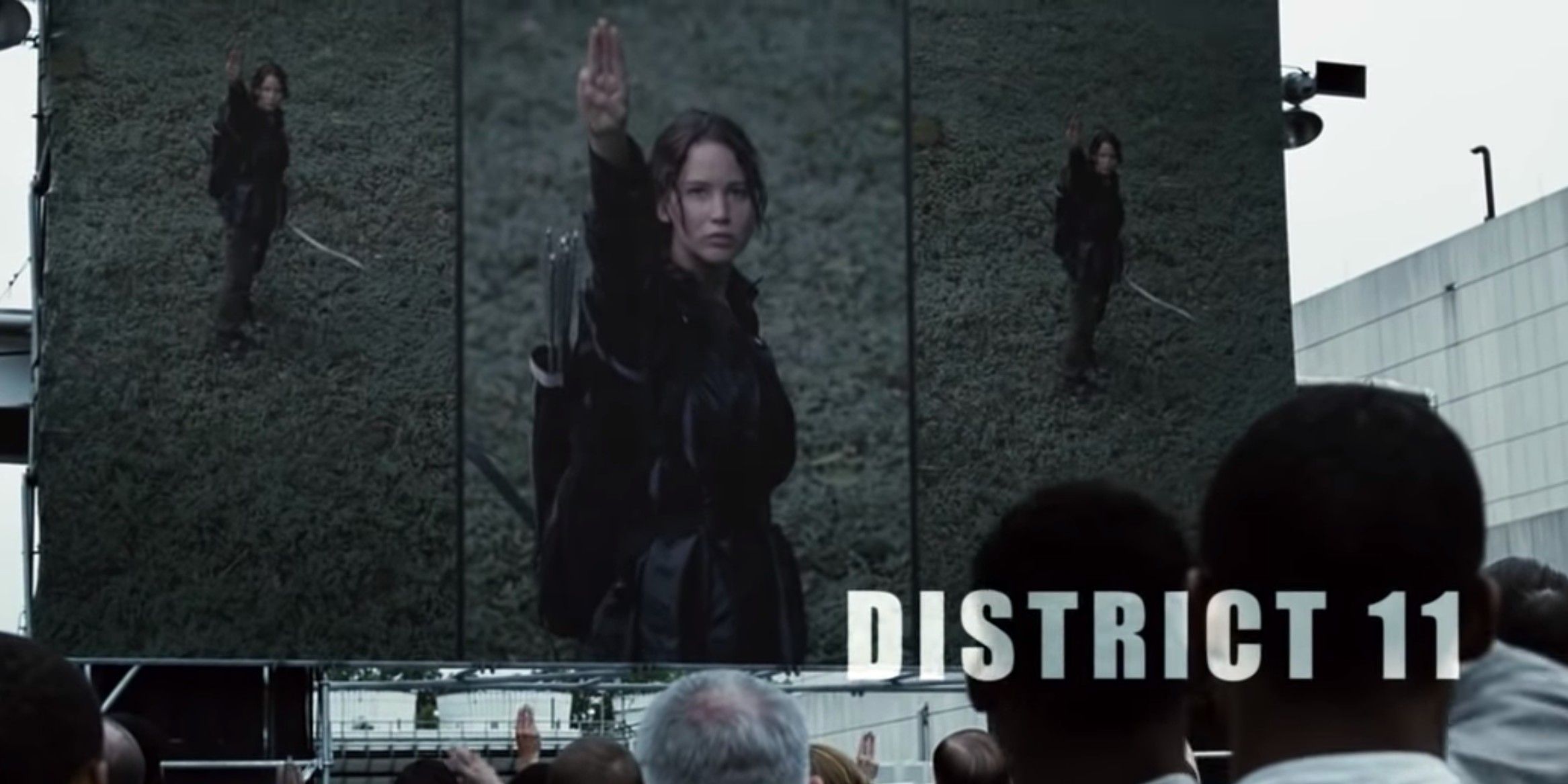 Katniss giving the salute as District 11 watches 