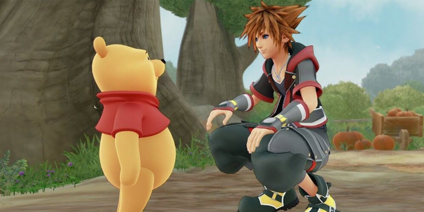 Sora sits on his haunches and talks to Winnie The Pooh in Kingdom Hearts