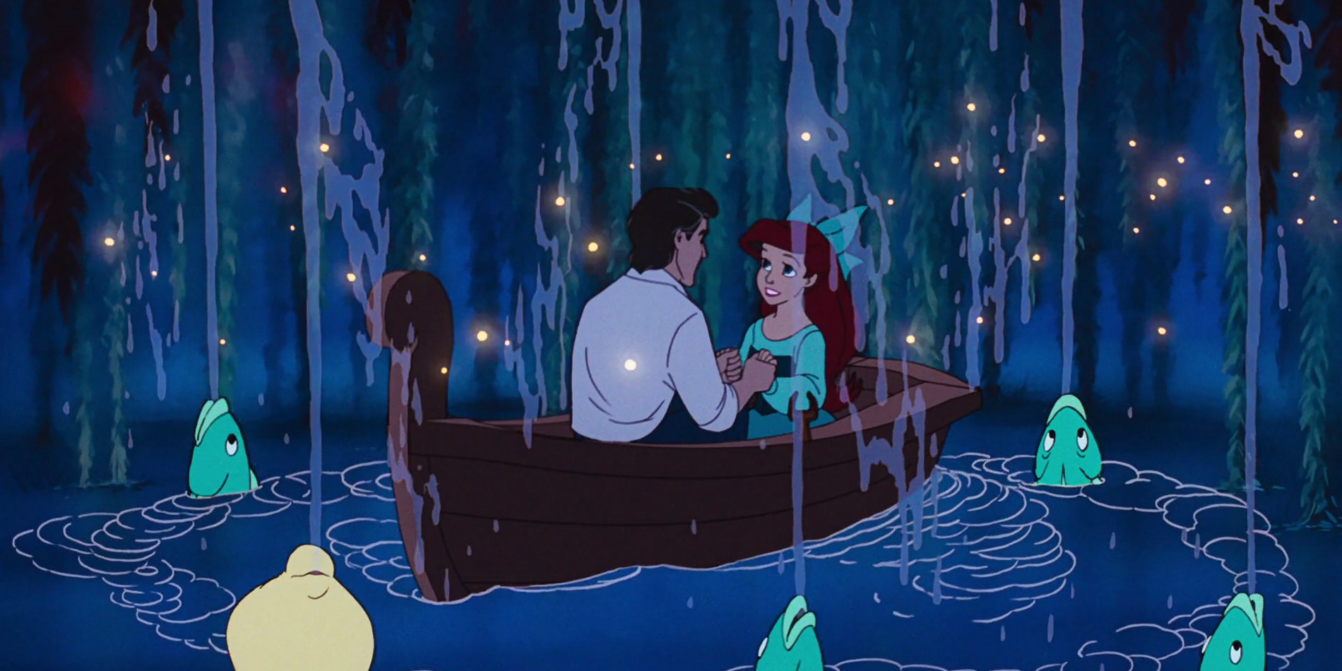 Ariel and Eric hold hands in a boat as fish spit water up around them