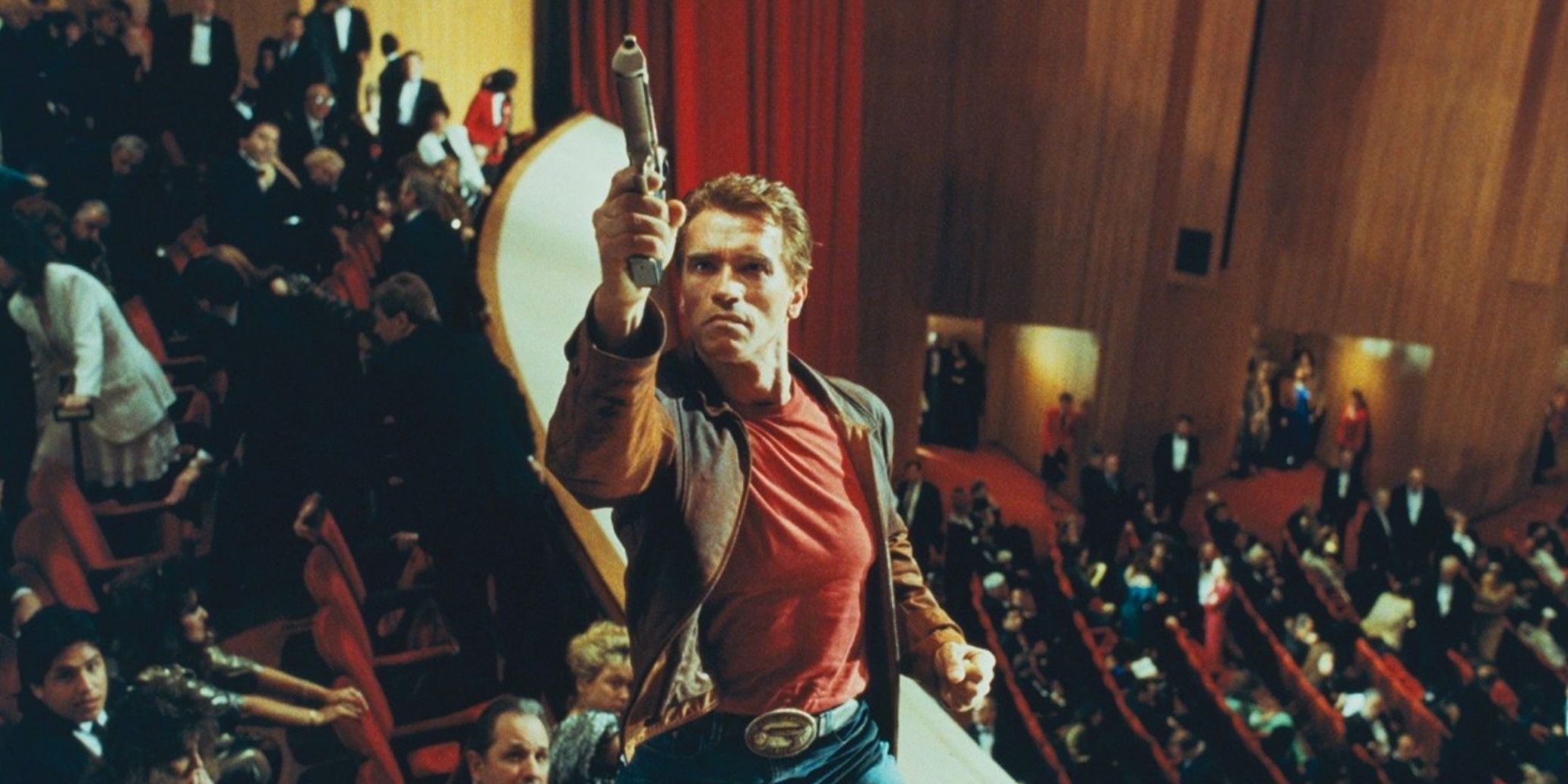 Arnold Schwarzenegger points a gun up in Last Action Hero
