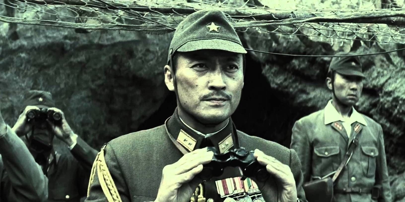Ken Watanabe as General Tadamichi Kuribayashi holding binoculars in a trench in Letters From Iwo Jima.