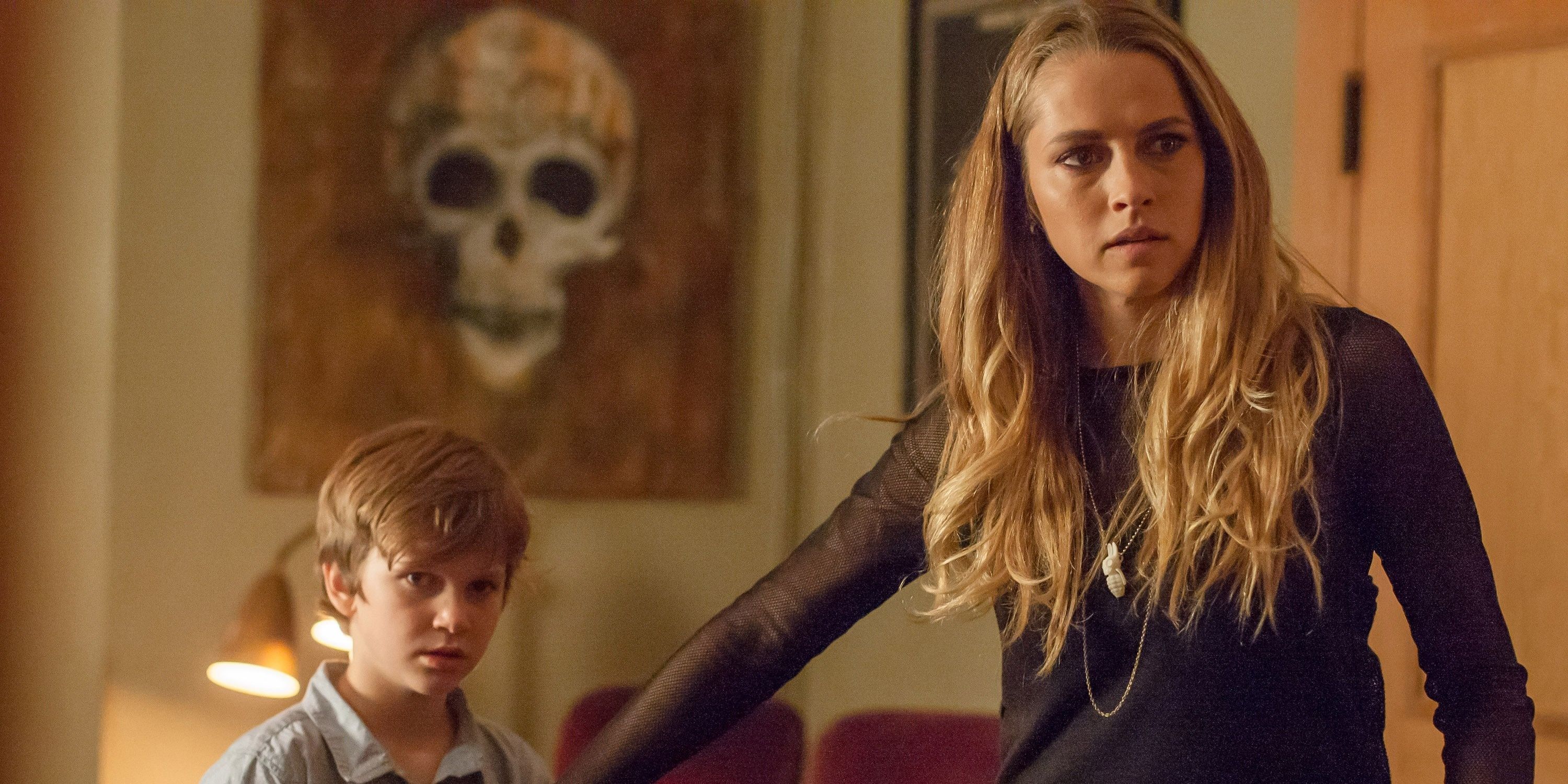Teresa Palmer, looking scared, holding boy's hand