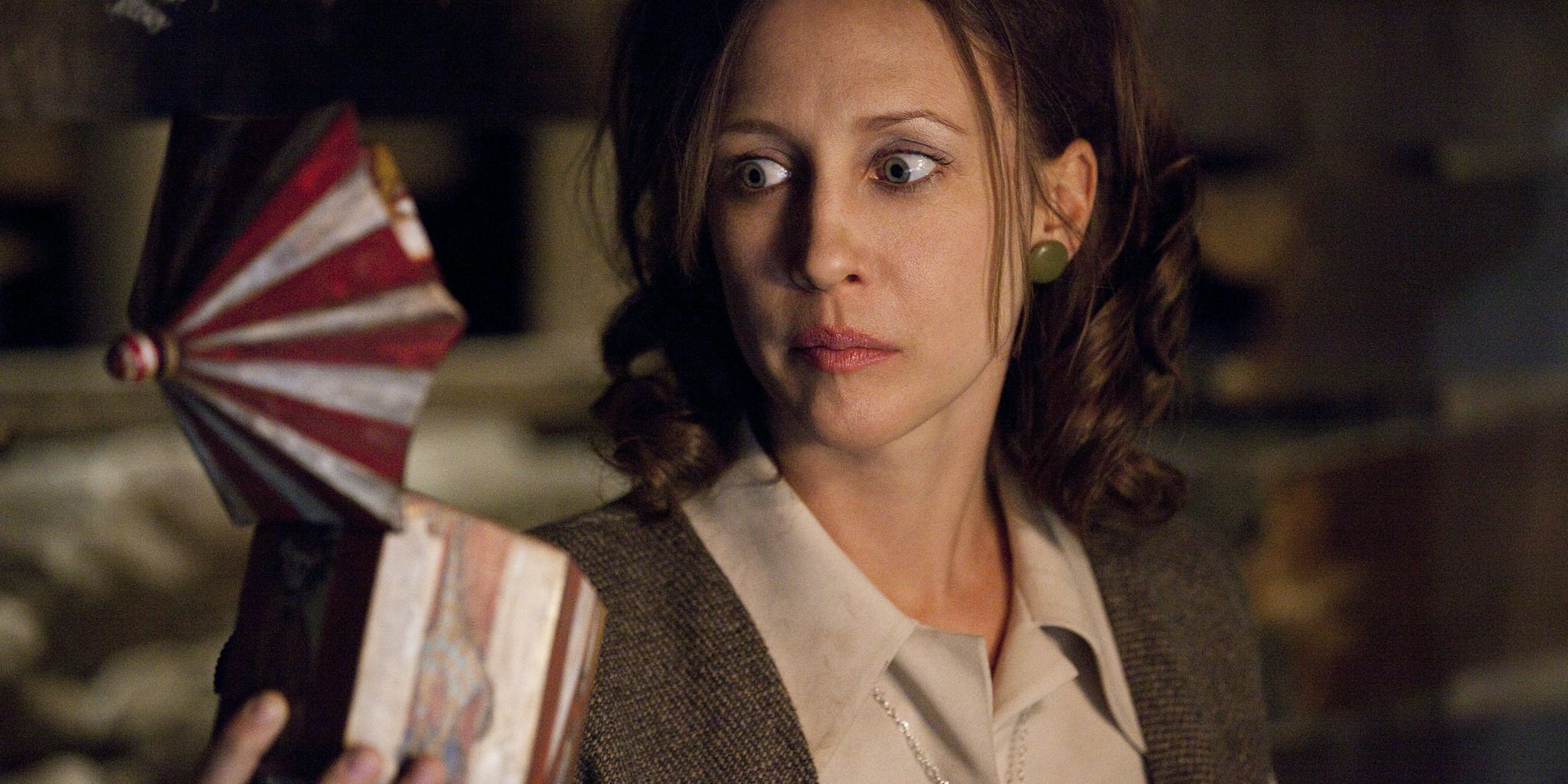 Lorraine Warren looking into the music box with wide eyes in The Conjuring 2013