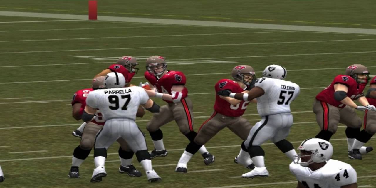 Football players from the Tampa Bay Buccaneers and Las Vegas Raiders jostling with each other on the field.
