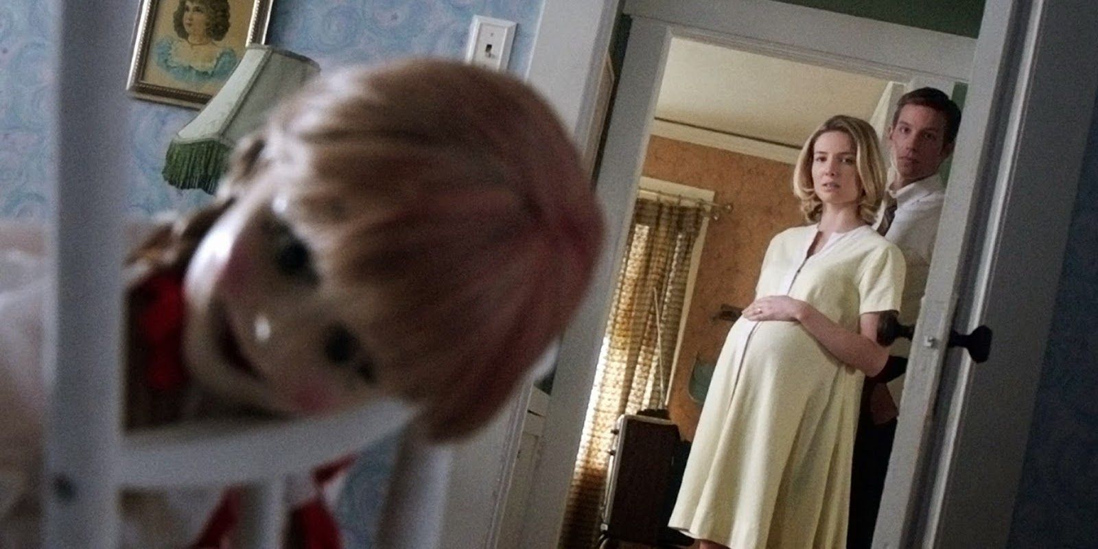 Mia and John look through the open doorway at Annabelle in Annabelle 2014
