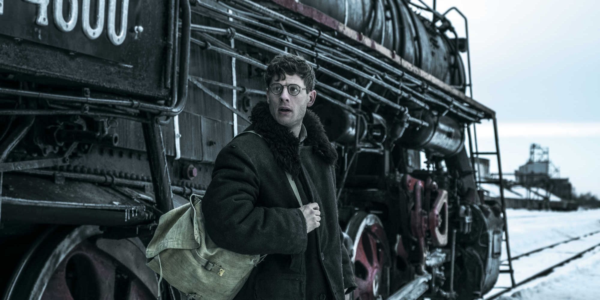 James Norton next to a train in Mr. Jones