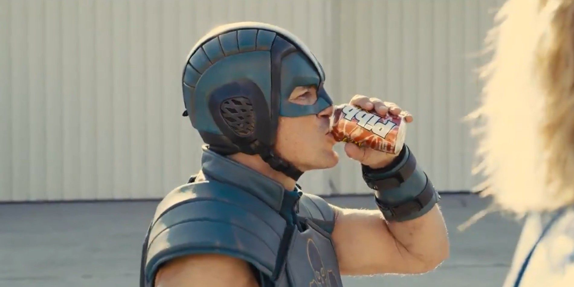 Nathan Fillion as TDK drinking a soda in The Suicide Squad