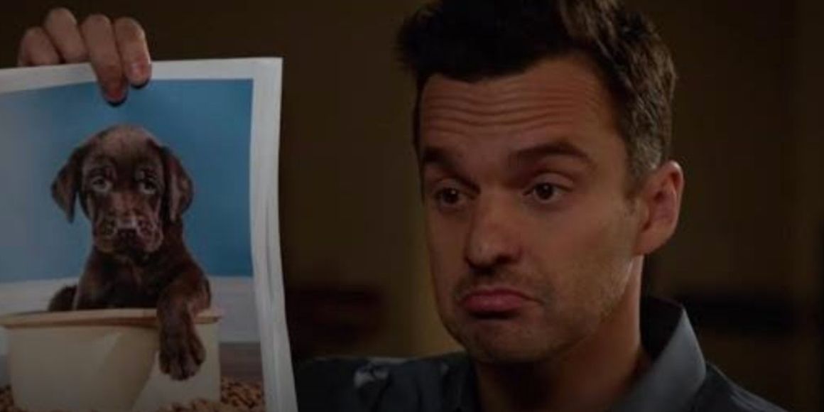 Nick holds a picture of a puppy in New Girl
