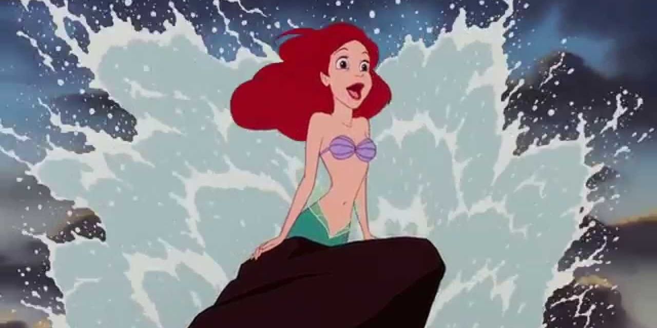 Ariel leaps out from behind a rock with water splashes behind her from The Little Mermaid