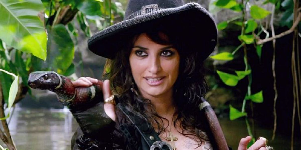 Angelica from Pirates of the Caribbean brandishing sword and smiling.