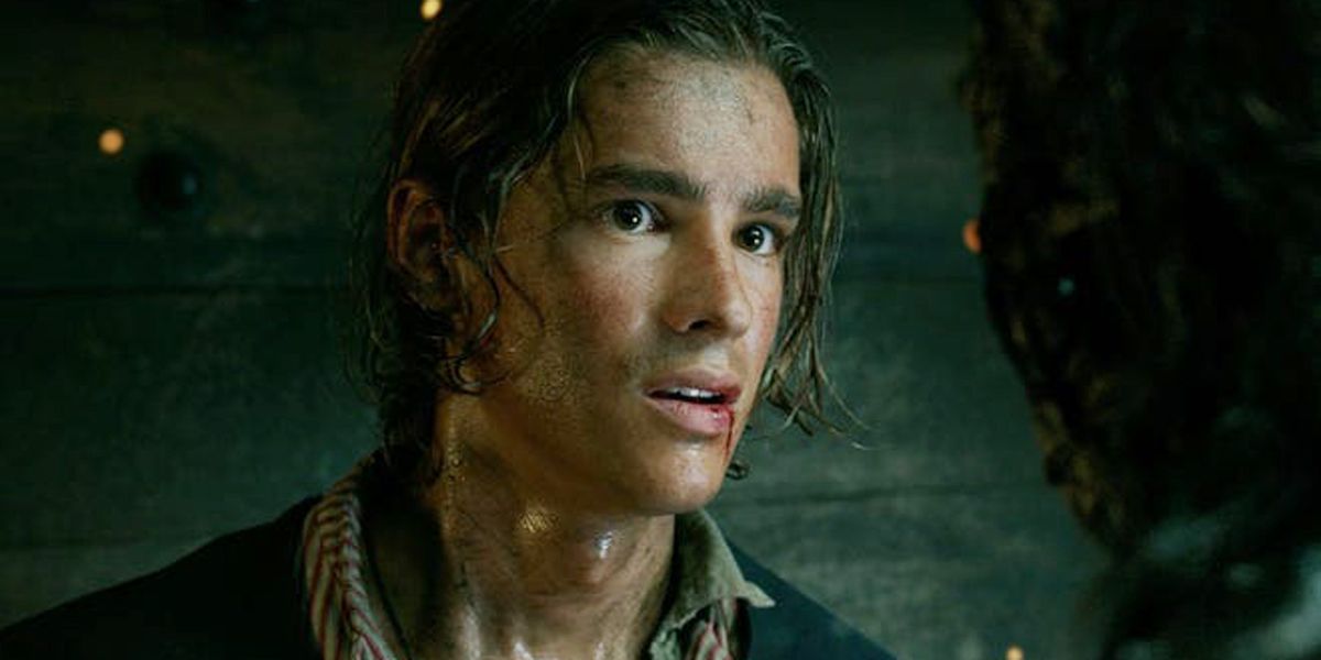 Henry Turner from Pirates of the Caribbean in a dark scene with blood on his lip.