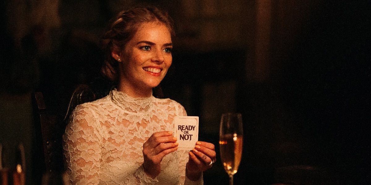 Samara Weaving in her wedding dress, drawing the ill-fated card in Ready or Not