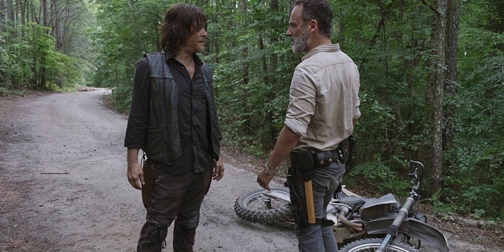 Rick and Daryl argue on the road next to a motorbike 