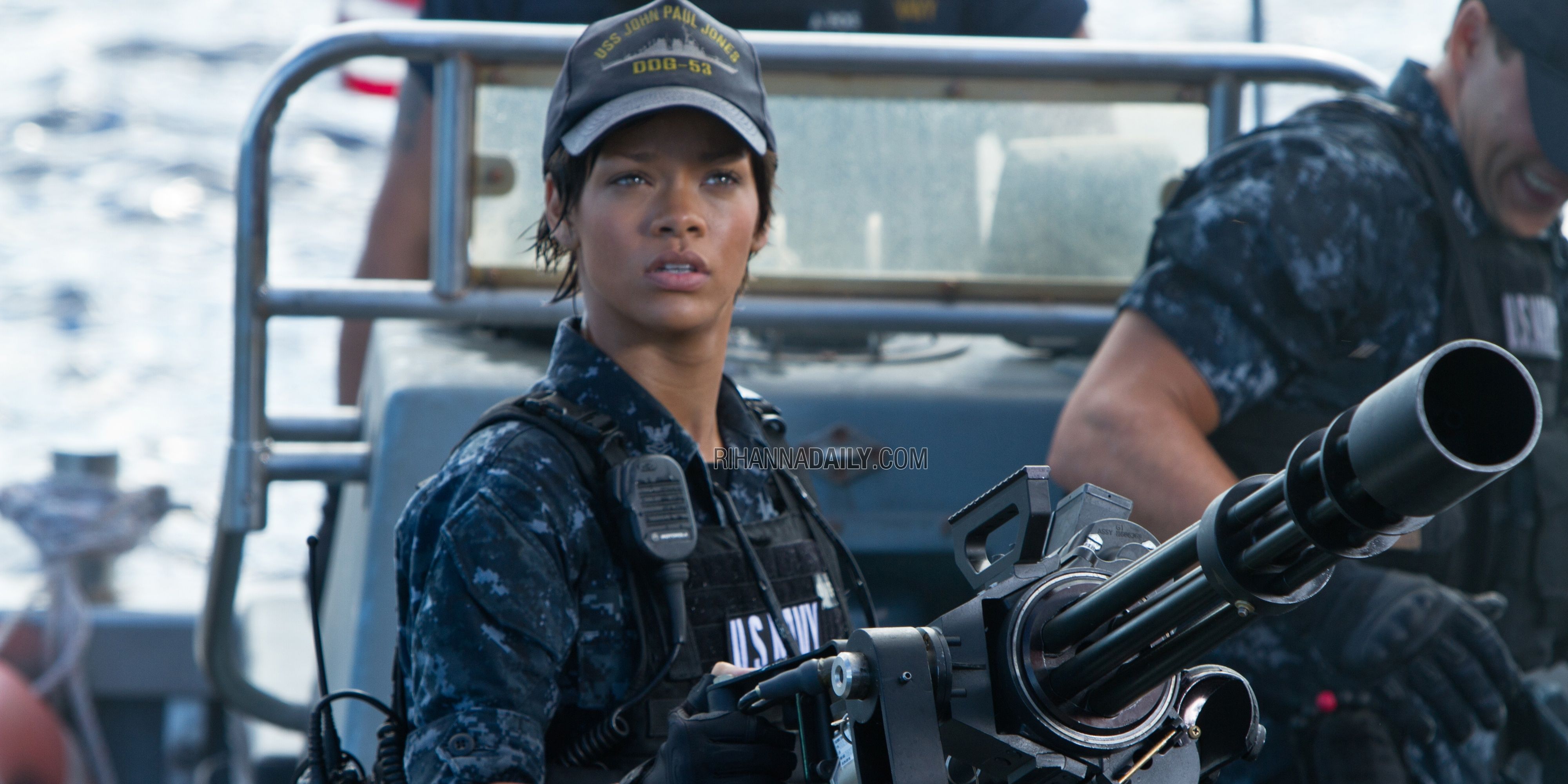 Rihanna in Battleship as a military officer with a minigun