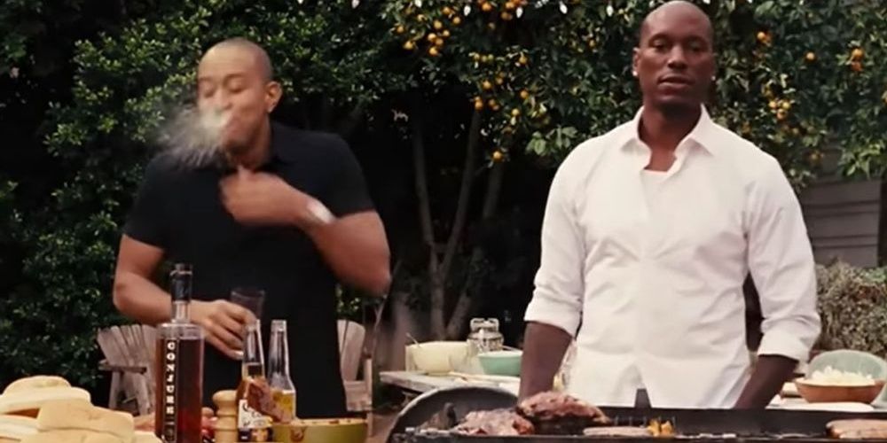 Tej spits out his drink at the BBQ in Fate of the Furious