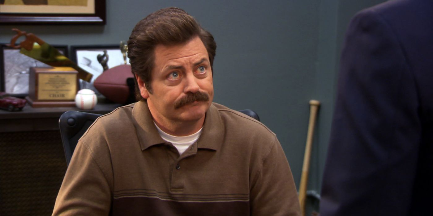 Ron Swanson looking up at someone from his desk in Parks and Rec