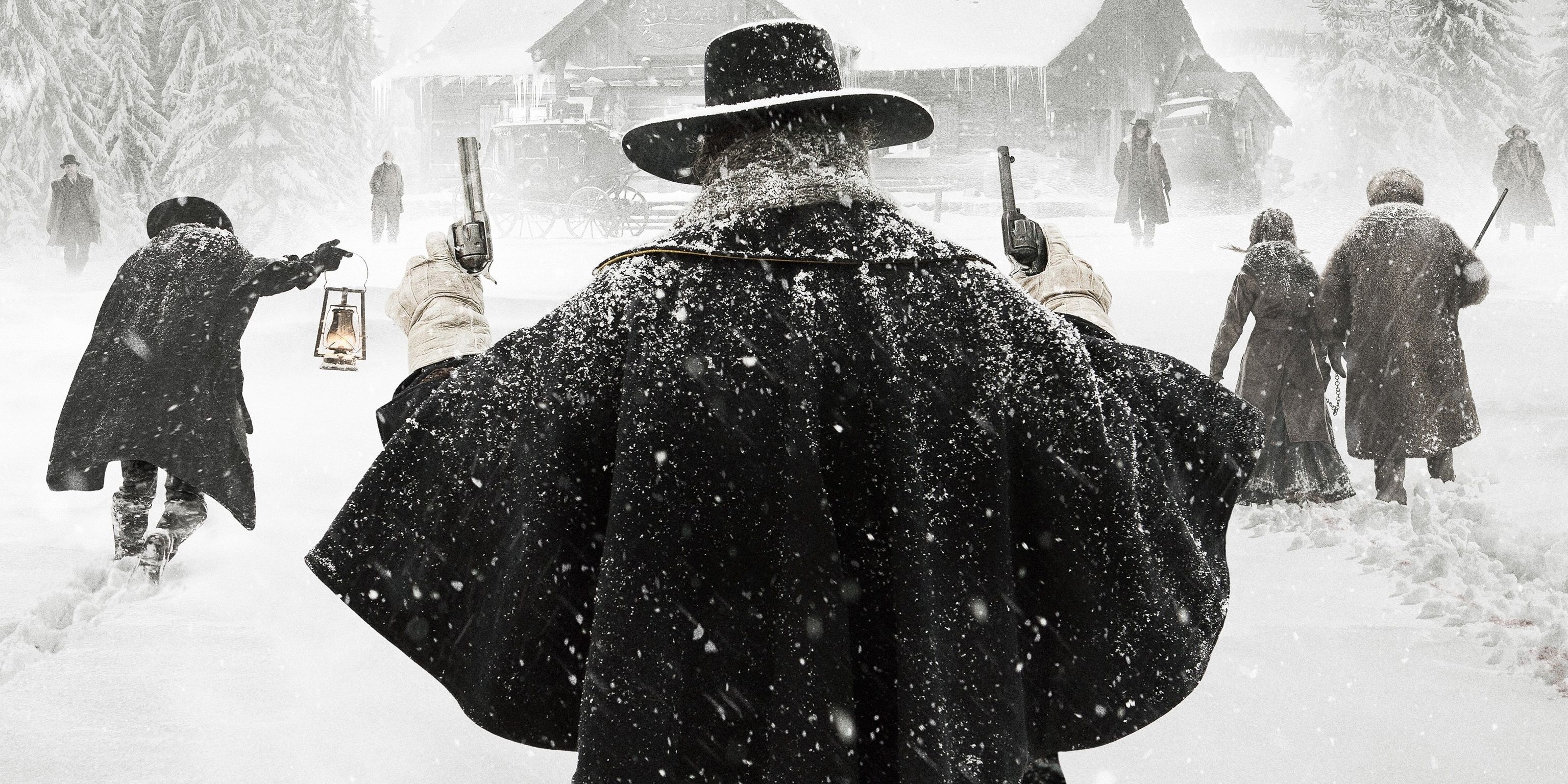 Samuel L. Jackson in The Hateful Eight standing in snow holding up two revolvers
