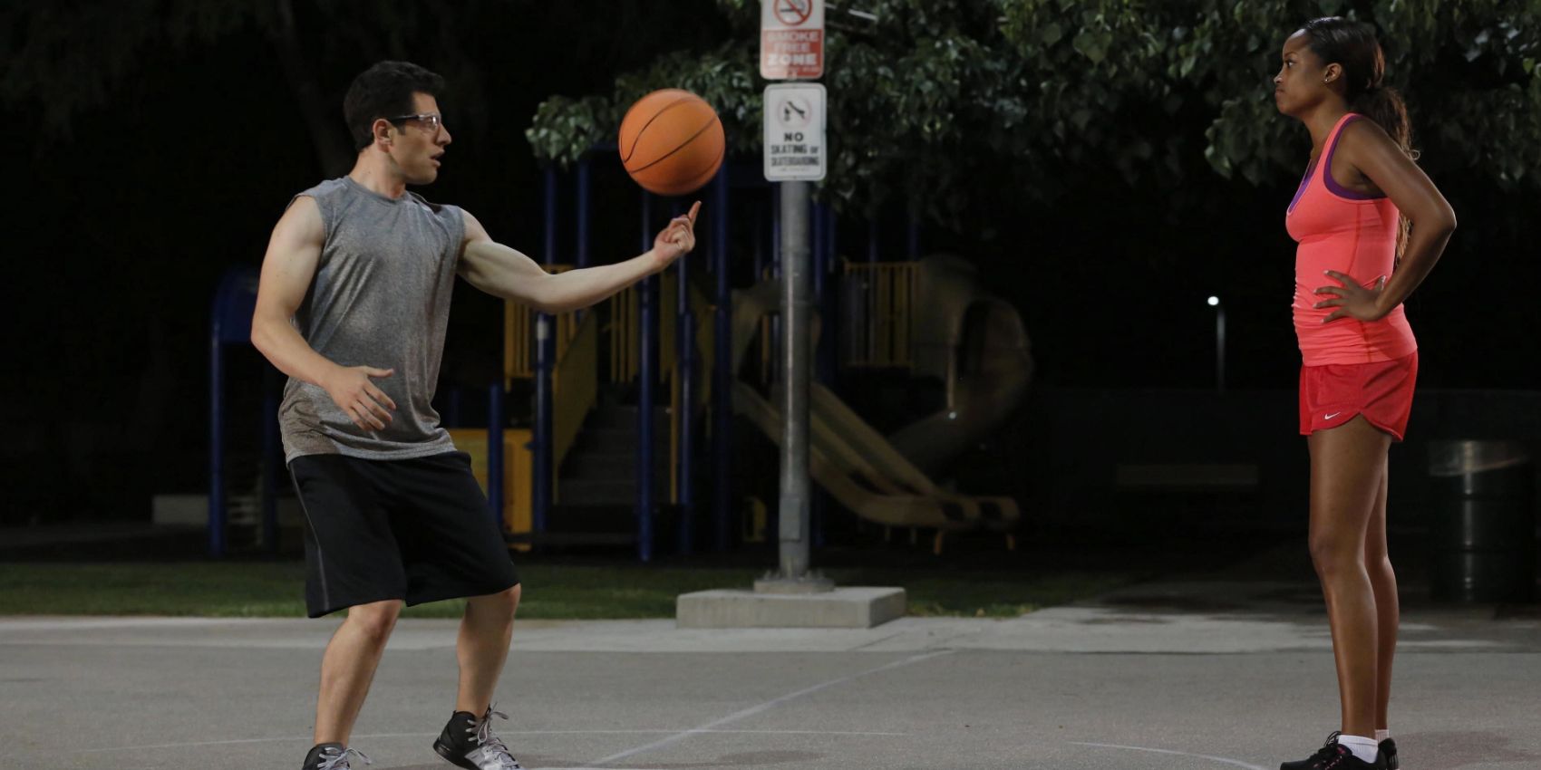 Schmidt tries to spin a basketball while on a court with Winston's sister Katie in New Girl