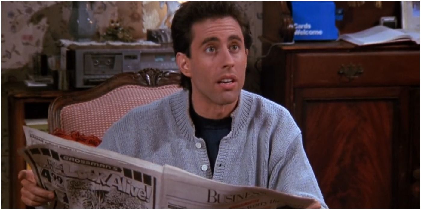 Jerry holding the newspaper on Seinfeld