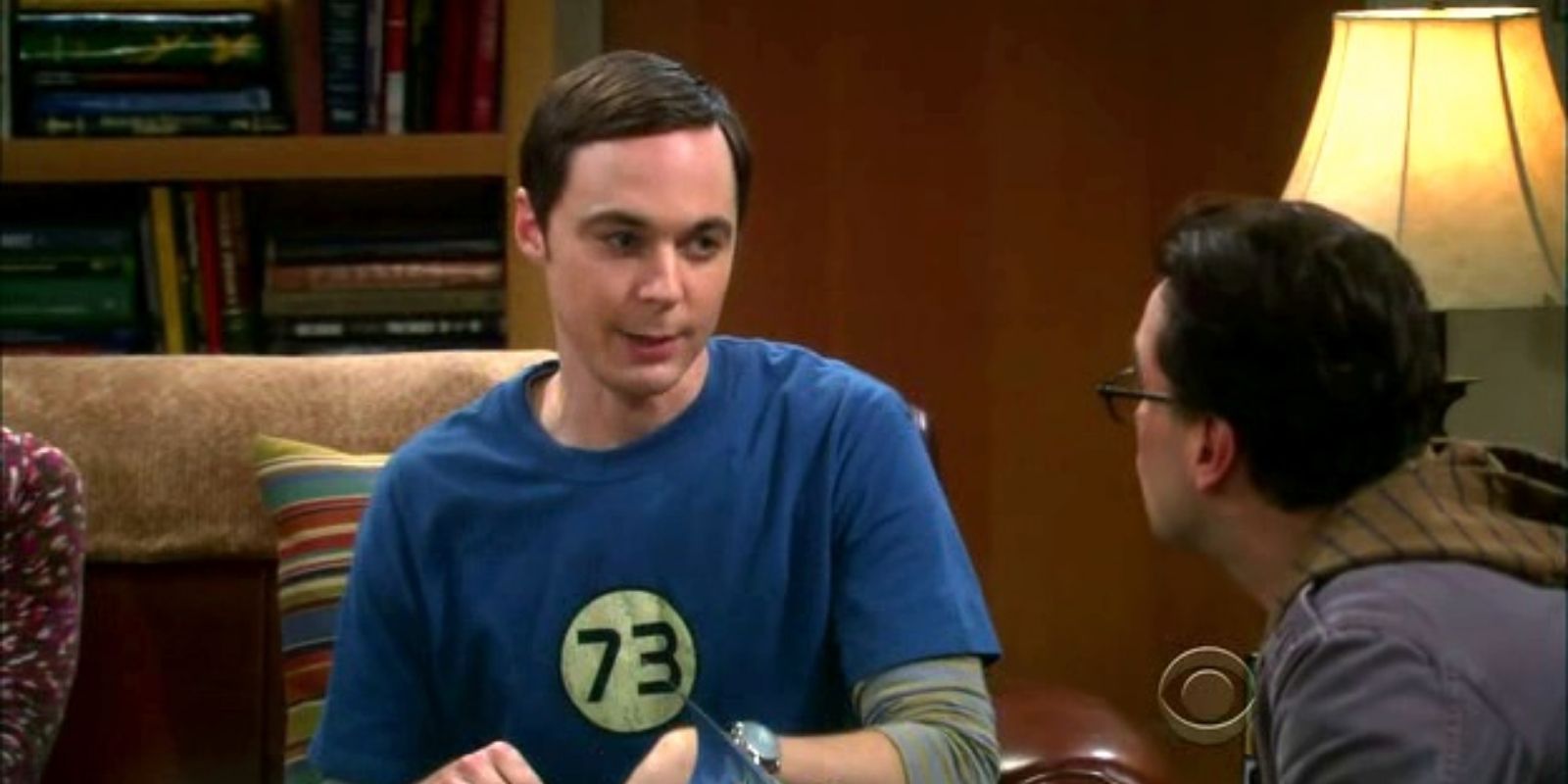 Sheldon Cooper wearing a blue shirt with the number 73 in a circle in The Big Bang Theory
