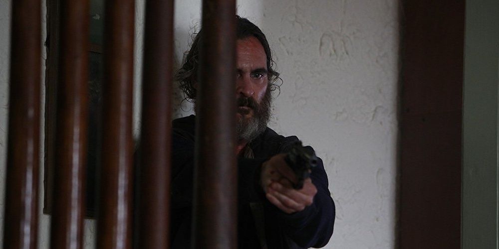 Scene from You Were Never Really Here with Joaquin Phoenix pointing gun
