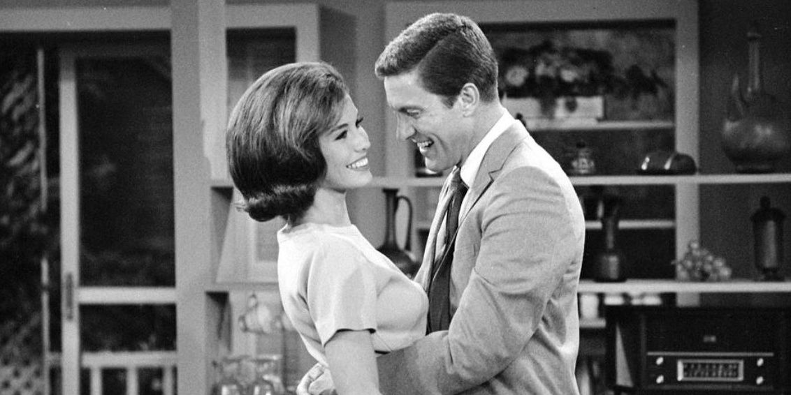 Rob (Dick Van Dyke) and Laura Petrie (Mary Tyler Moore) smiling and looking at each other in &quot;The Dick Van Dyke Show.&quot;